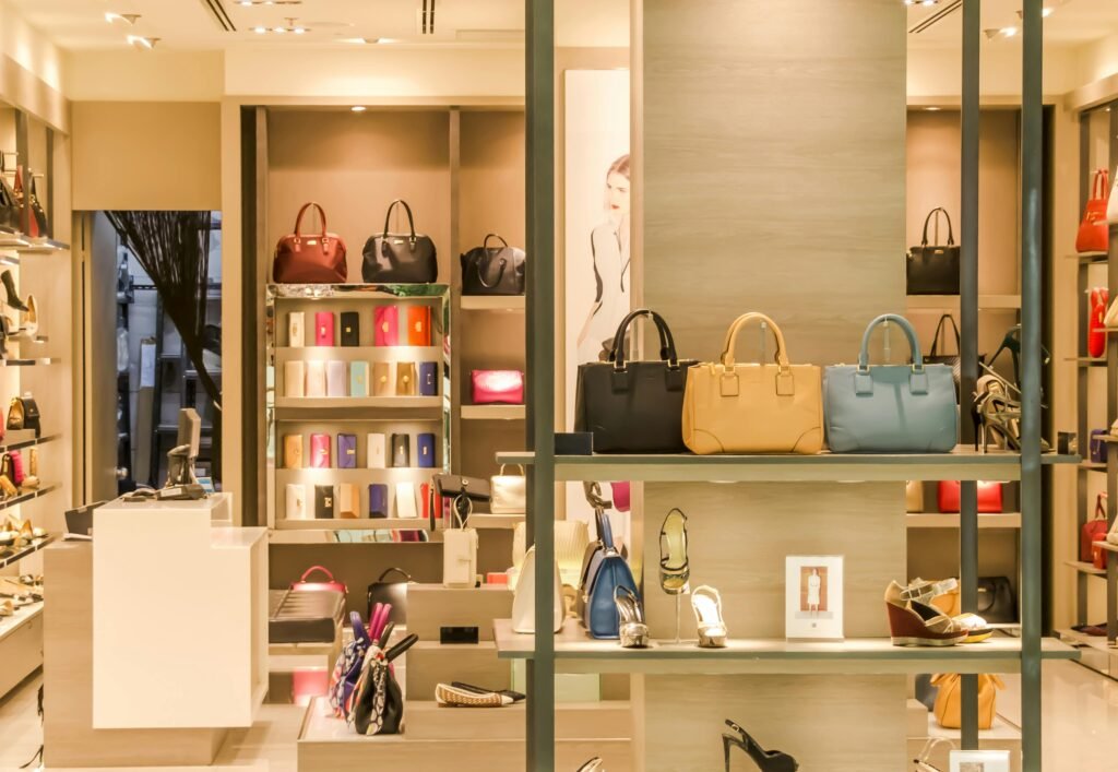 Chic boutique with a variety of handbags and shoes elegantly displayed on shelves.